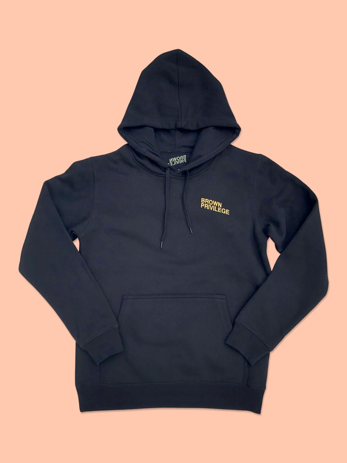 Black and gold Brown Privilege hoodie on peach