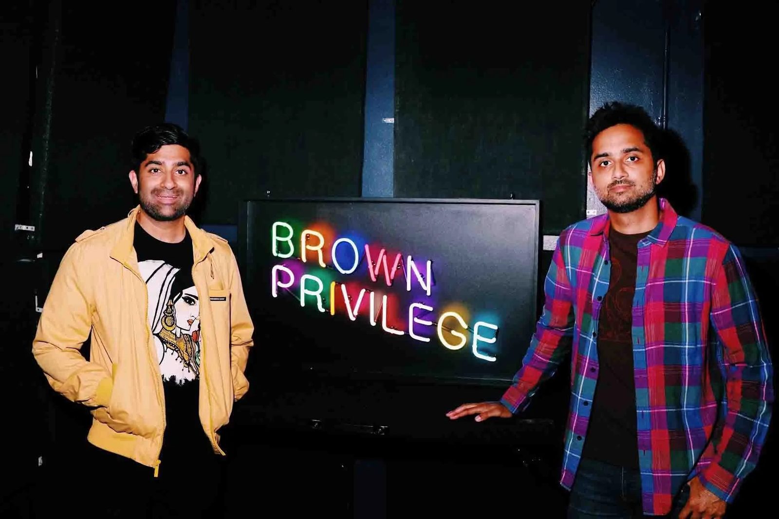 Choksi and Sareen in front of the Brown Privilege neon sign